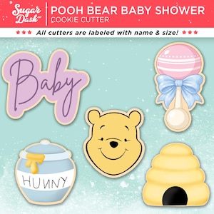May include: A collection of cookie cutters with a baby shower theme. The cutters include the word "Baby", a baby rattle, Winnie the Pooh's face, a honey pot with the word "Hunny", and a beehive. The text "POOH BEAR BABY SHOWER" is at the top.