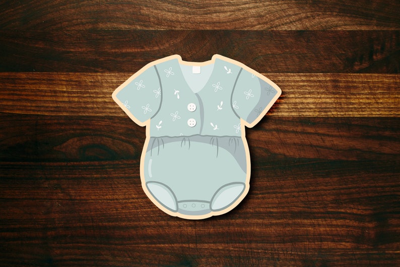 May include: A light blue baby onesie with a white floral pattern and white buttons. The onesie has a snap closure at the bottom.