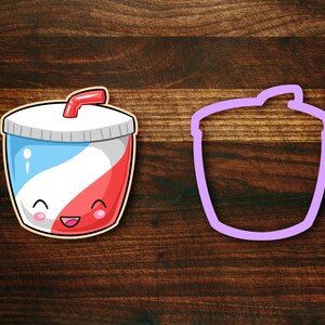 May include: A red, white, and blue cartoon soda cup with a straw and a smiling face. The cup is next to a purple outline of the same cup.