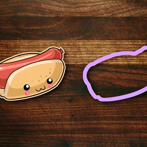 May include: A cartoon hot dog in a bun with a cute face. The hot dog is red and the bun is yellow. There is a purple outline of the hot dog around it.