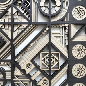 May include: A black and white geometric design with layered circles, squares, and triangles. The design is made of wood and has a 3D effect.