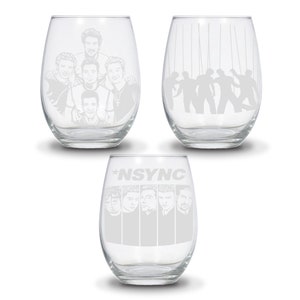 May include: Set of three clear glass wine glasses with etched designs featuring the boy band *NSYNC. One glass features a silhouette of the band members, another features a portrait of the band members, and the third glass features the band's name and individual portraits of the band members.