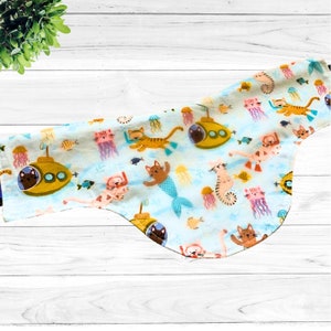 May include: Light blue cat-themed fabric featuring cartoon cats with scuba gear, mer-cats, yellow submarines, jellyfish, and fish. The fabric is suitable for various craft projects, including pet bandanas and accessories.