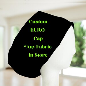 May include: Black custom EURO cap with the text "*Any Fabric in Store" printed in green.