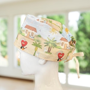 May include: A scrub cap featuring a light-colored fabric with a tropical print. The pattern includes small houses, palm trees, suns, and red heart-shaped characters with single eyes. The cap has a tie-back closure with beige fabric ribbons.