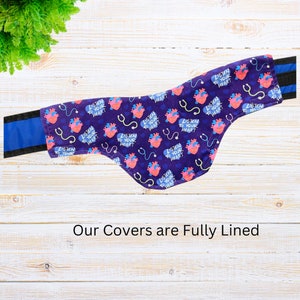 May include: Purple fabric cover with a heart and stethoscope pattern. The fabric has the text "Listen to your heart" repeated throughout. The cover is fully lined.