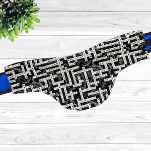 May include: Black and white fabric with a crossword puzzle design featuring medical terms related to anesthesia. The fabric has a blue trim.