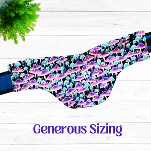 May include: A black bandana with a psychedelic mushroom print in shades of purple, pink, and blue. The bandana has a blue trim and the text "Generous Sizing" is printed below the bandana.