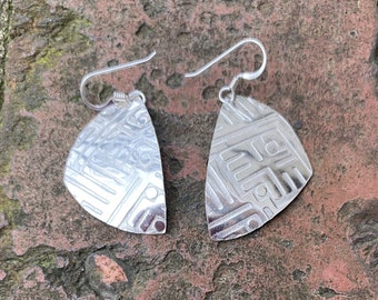 Rounded triangular shaped deeply patterned sterling silver dangling earrings