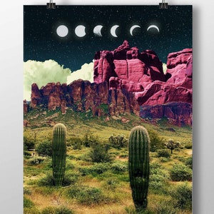 May include: A digital art print featuring a desert landscape with two tall cacti in the foreground. The background shows a mountain range with a pink hue and a night sky with a series of white crescent moons.