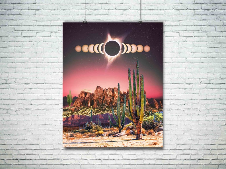 May include: A digital art print featuring a desert landscape with tall cacti and a red sky. The sun is partially eclipsed by the moon, with a ring of light around it. The print has a retro, psychedelic vibe.