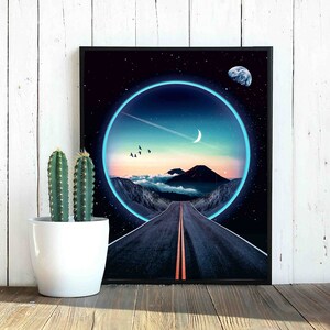 May include: A framed print of a digital art piece depicting a road leading into a glowing blue circle. The circle is set against a dark blue sky with stars and a crescent moon. A small planet is visible in the upper right corner.