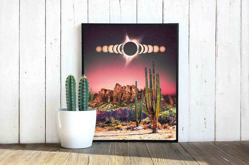 May include: A digital art print featuring a desert landscape with a red sky and a large black sun with a white halo. The sun is surrounded by a series of smaller circles, representing the phases of the moon. The desert landscape includes tall cacti and mountains in the background.