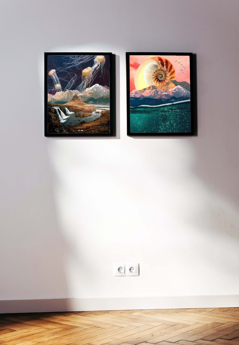 May include: Two framed art prints on a white wall. The print on the left features a landscape with a waterfall and jellyfish in the sky. The print on the right features a seashell with a mountain range in the background.