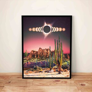 May include: A digital art print featuring a desert landscape with a large cactus in the foreground. The sky is a vibrant pink and purple with a solar eclipse in the center. The eclipse is depicted as a series of overlapping circles, showing the progression of the event.