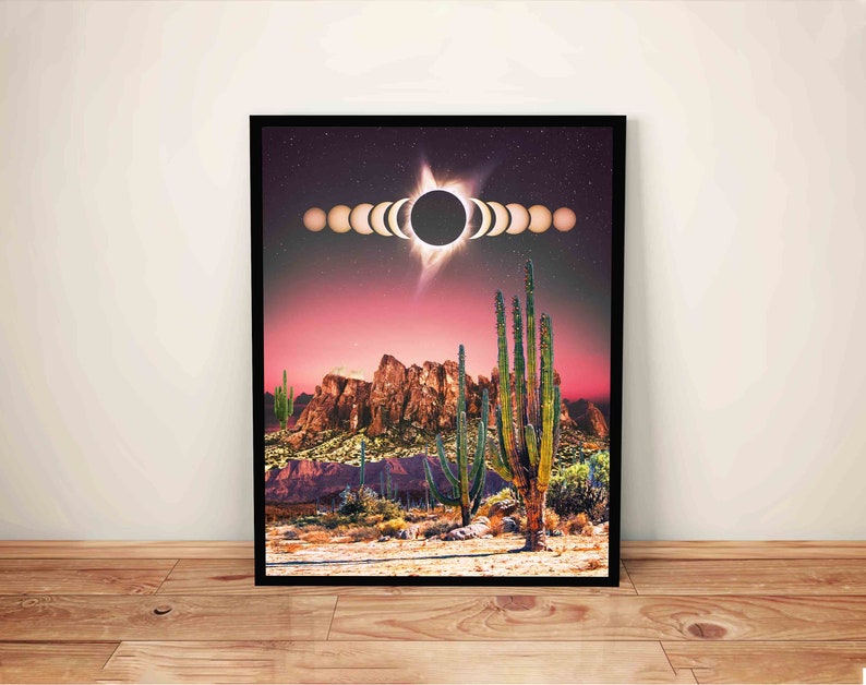 May include: A digital art print featuring a desert landscape with a large cactus in the foreground. The sky is a vibrant pink and purple with a solar eclipse in the center. The eclipse is depicted as a series of overlapping circles, showing the progression of the event.