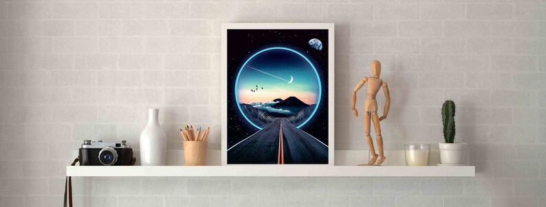 May include: A framed print of a digital art piece depicting a road leading into a glowing blue circle in a dark sky with stars and a crescent moon. The road is surrounded by mountains and clouds.