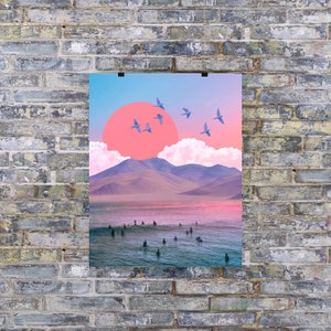 May include: A digital collage featuring a pink sunset over a mountain range with a blue sky and birds flying. The bottom of the image shows a group of surfers in the ocean.