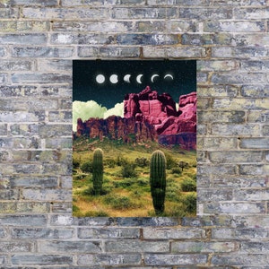 May include: A digital art print featuring a desert landscape with red rock formations and two tall cacti. The sky is dark blue with a white crescent moon and phases of the moon.