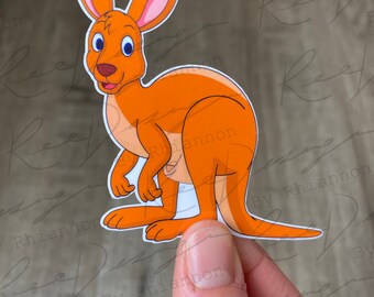 May include: A cartoon kangaroo with orange fur, blue eyes, and a white belly. The kangaroo is standing on its hind legs with its tail curled behind it.