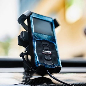 May include: A black and blue car air suspension control unit with a digital display and the text "AIRLIFT PERFORMANCE" on the front.