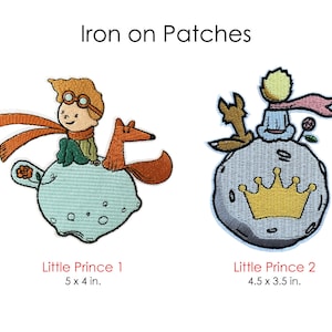 May include: Two iron-on patches featuring the Little Prince. The first patch shows the Little Prince sitting on a blue planet with a fox. The second patch shows the Little Prince sitting on a grey planet with a fox and a crown. The patches are 5 x 4 inches and 4.5 x 3.5 inches.