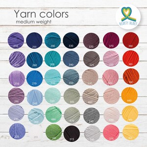 May include: A color chart displaying forty-two circular swatches of medium weight yarn in various shades including purple, blue, teal, brown, pink, red, orange, yellow, green, gray, and white, each labeled with a three-digit numerical code.