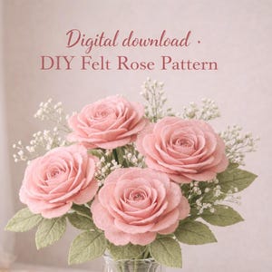 May include: A display of pink felt roses in a clear glass vase. The roses are accompanied by green felt leaves and small white flowers. The image includes the text "Digital download. DIY Felt Rose Pattern".