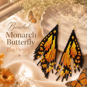 May include: A pair of long, triangular beaded earrings featuring a monarch butterfly wing pattern in black, orange, and yellow seed beads. The earrings have gold-toned hooks and a fringe design. The text "Beaded Monarch Butterfly Earrings" is visible.