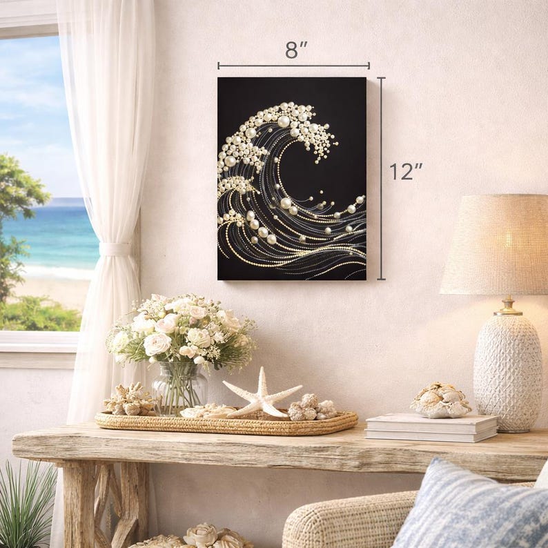 May include: A black canvas art piece depicting a wave design, embellished with white pearls and gold accents. The artwork measures 8 inches wide and 12 inches high. The wave design is a decorative element for coastal or nautical themed decor.
