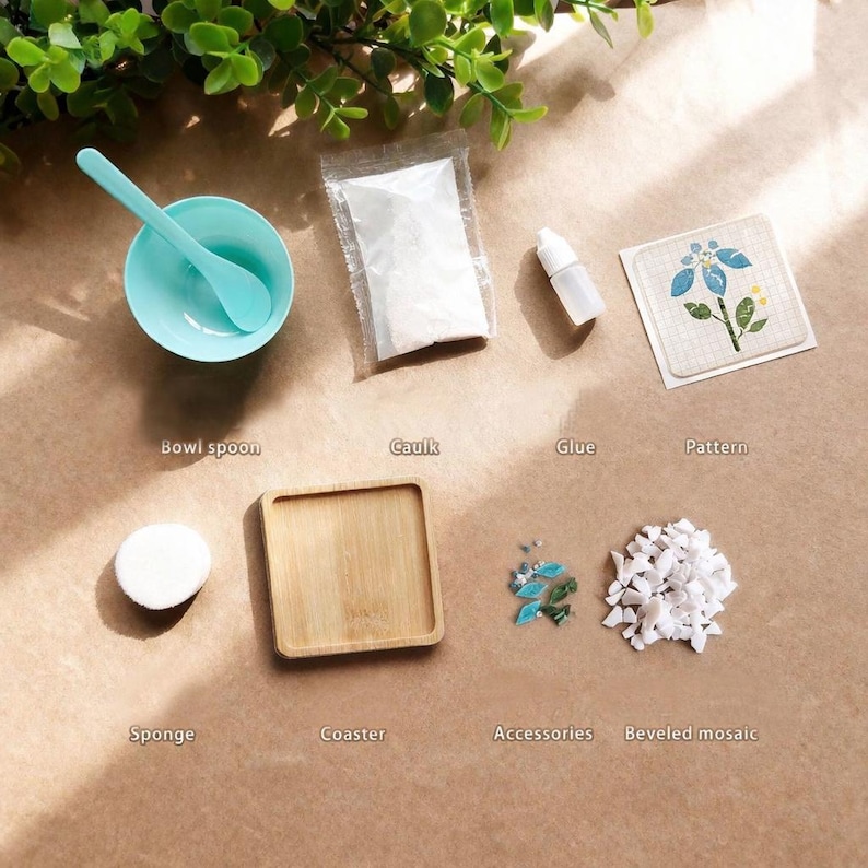 May include: An assortment of craft supplies, including a teal bowl and spoon, a small wooden coaster, a sponge, and packets of caulk and glue. Additional elements include a floral pattern, accessories, and beveled mosaic pieces. The items are arranged on a brown surface.