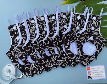 May include: A collection of eight small, decorative stockings with a brown and white floral pattern. Each stocking has a white trim, a light blue interior, and a white loop for hanging. A white leash with a silver clasp is also included.