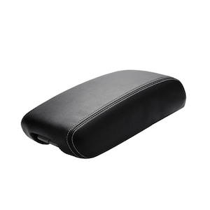 May include: Black leather armrest cover with white stitching.