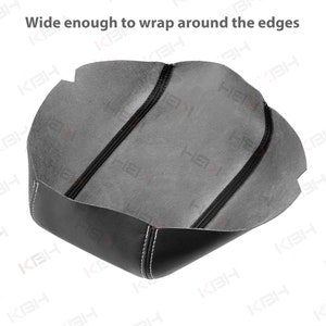 May include: Black leather car seat cover with white stitching. The interior is gray. The text "Wide enough to wrap around the edges" is visible at the top. The cover is designed to fit around the edges of a car seat.