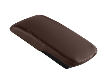 May include: A brown leather armrest for a car. The armrest is made of a soft, padded material and has a smooth, rounded shape.