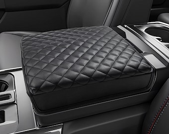 May include: Black quilted leather center console armrest cover for a car. The cover is made of soft, durable material and provides a comfortable resting place for your arm.