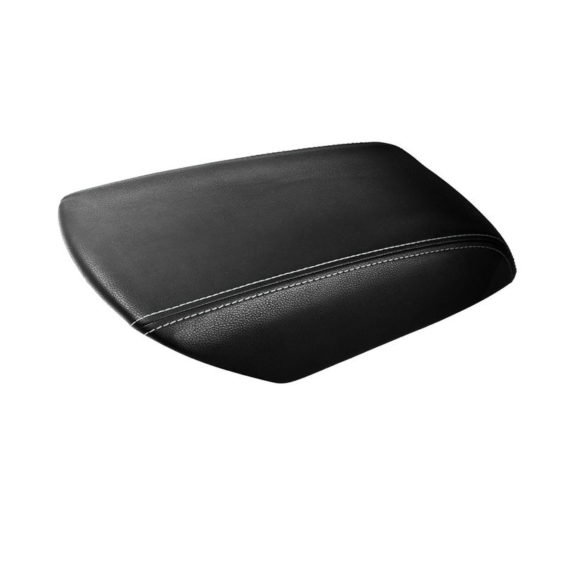 May include: Black, rectangular car armrest with white stitching. The armrest has a slightly curved top and is made of a smooth, leather-like material. The white stitching runs along the center of the armrest.