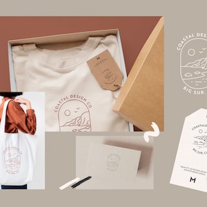 May include: A set of branding elements for a company called "Coastal Design Co." The logo features a line drawing of a coastal scene with a sun, cliffs, and ocean waves. The text "Big Sur, CA" is below the logo. The branding elements are displayed on a tote bag, t-shirt, and hang tag.