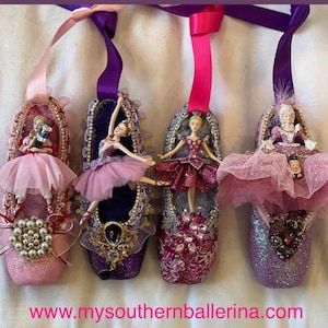 May include: Four pink and purple ballet slipper ornaments with miniature ballerinas and other figures inside. The ornaments are decorated with glitter, rhinestones, and beads. The website www.mysouthernballerina.com is displayed at the bottom of the image.