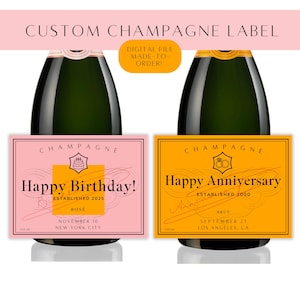 May include: Two champagne bottles with custom labels. One label is pink with "Happy Birthday!" and the other is orange with "Happy Anniversary!". Both labels include the word "Champagne" at the top.