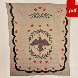 May include: A beige quilt with a black scalloped border. The centre features a brown eagle with a wreath of green leaves and the dates 1771 and 1846. The quilt is decorated with red stars.