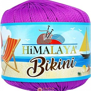 May include: A ball of vibrant purple yarn wrapped in a paper label featuring the brand name Himalaya, the product name Bikini, and a beach-themed illustration with a deck chair, a sailboat, and a ball of yarn with knitting needles.