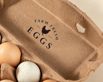 May include: A tan molded pulp egg carton with a black printed graphic of a chicken silhouette and the text FARM FRESH EGGS. The carton contains several eggs with varying shell colors, including light brown and speckled off-white varieties.