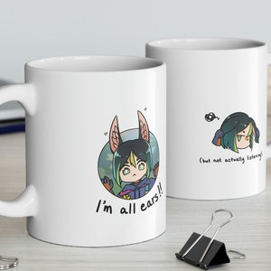 May include: Two white ceramic mugs with cartoon illustrations. One mug features a character with large ears and the text "I'm all ears!!". The other mug shows the same character with the text "(but not actually listening)".
