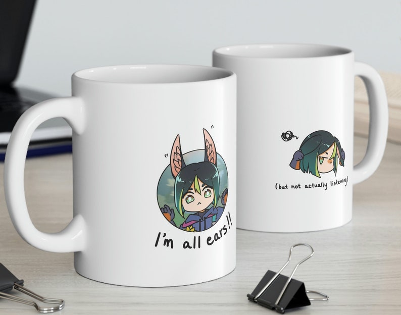 May include: Two white ceramic mugs with cartoon illustrations. One mug features a character with large ears and the text "I'm all ears!!". The other mug shows the same character with the text "(but not actually listening)".