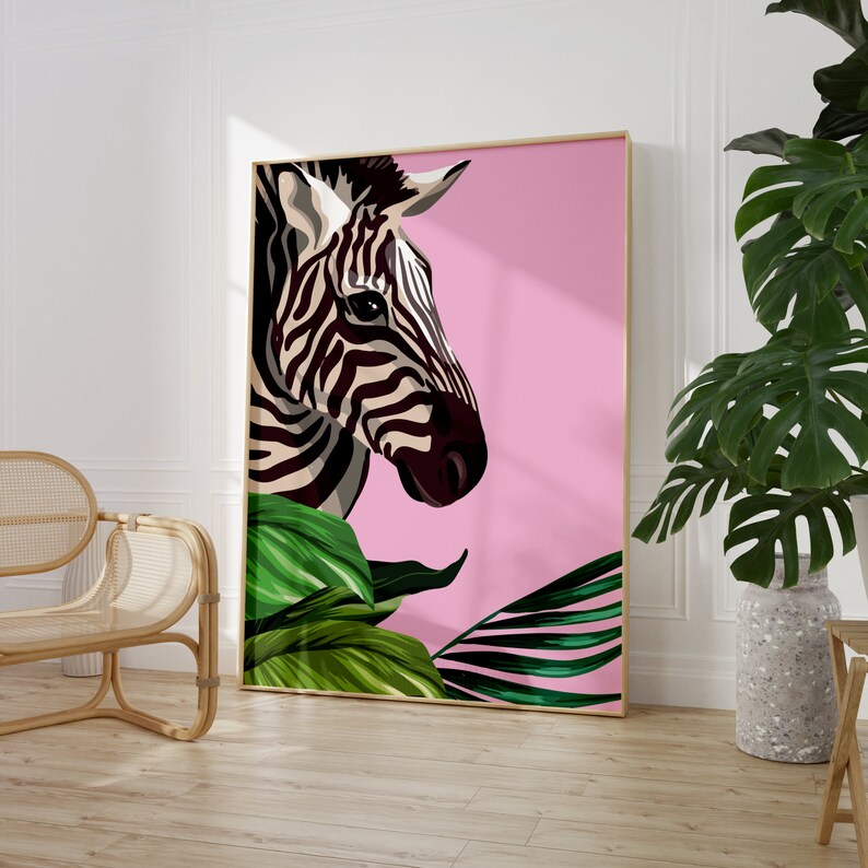 May include: A pink background with a black and white zebra head and green tropical leaves. The zebra is looking to the right.