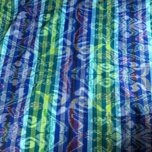 May include: A blue and green striped fabric with a woven pattern. The fabric has a subtle sheen and a soft texture.