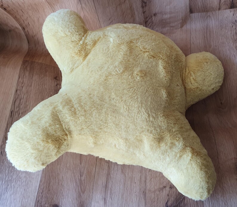 May include: A yellow plush pillow shaped like a star. The pillow is soft and fluffy, and it would be perfect for cuddling.