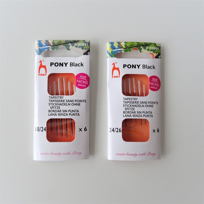 May include: Two packages of Pony Black tapestry needles. The package on the left contains six needles sized 18/24. The package on the right contains six needles sized 24/26. Both packages have the text "not nickel plated" on them.