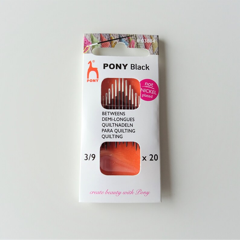 May include: A package of 20 black quilting needles, size 3/9, by PONY. The needles are not nickel plated. The package is orange and white with the text "PONY Black" and "create beauty with Pony".